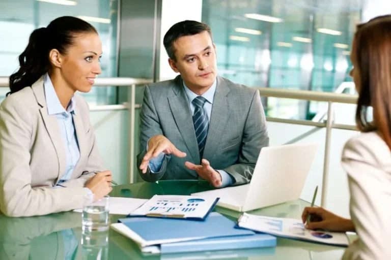 Commercial finance advisors working with borrowers reviewing loan options and funding structure